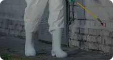 Pest control technician in protective gear applying treatment to a wall, emphasizing Wise Pest Control's rodent and pest management services in Los Angeles County.