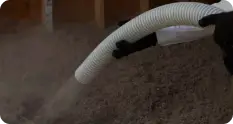 Pest control technician installing TAP insulation to enhance energy efficiency and protect against pests.